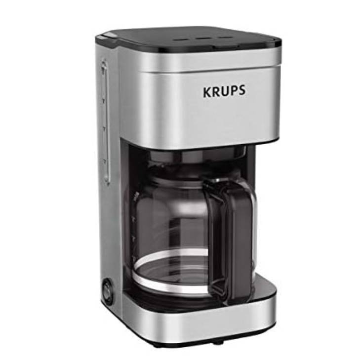 A KRUPS 10-cup coffee maker with a stainless steel finish features a glass carafe and a side water level indicator, equipped with a power button located on the bottom left.