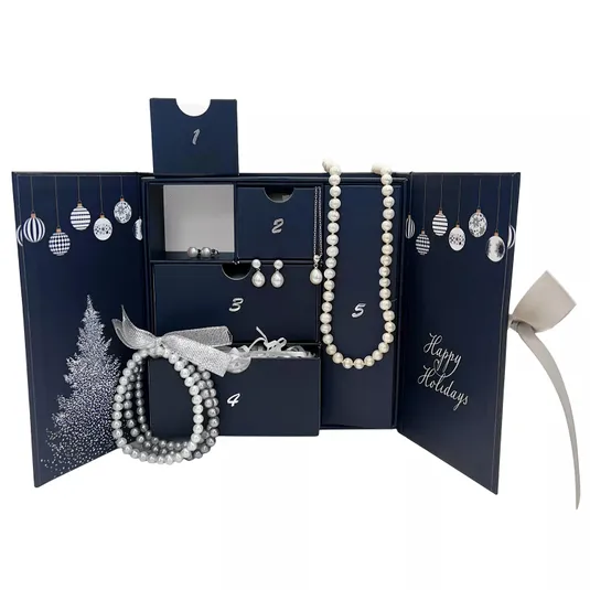A navy holiday-themed advent calendar is displayed, featuring five numbered compartments containing various pearl jewelry items, including necklaces, bracelets, and earrings.