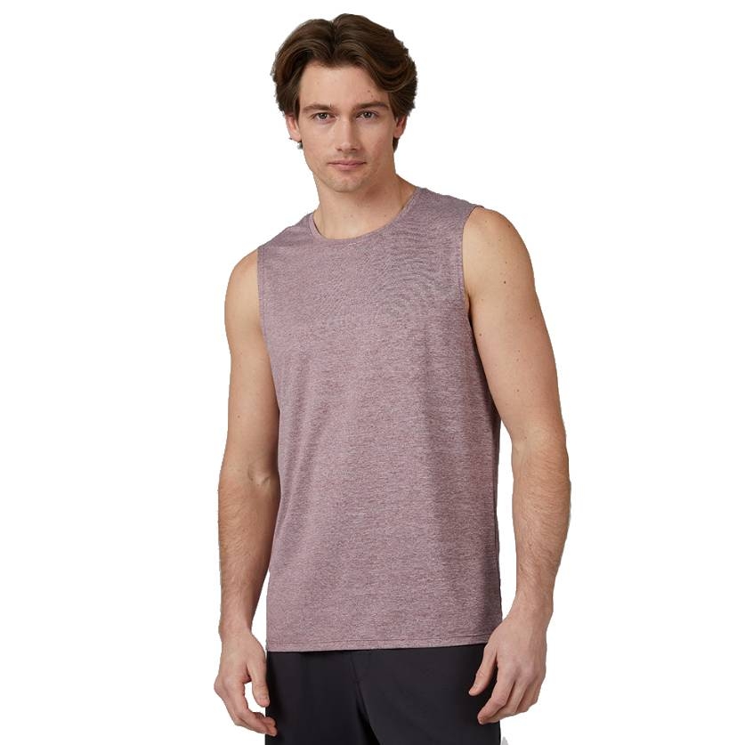 A man is wearing a sleeveless, light purple heathered tank top and black shorts, showcasing casual activewear.