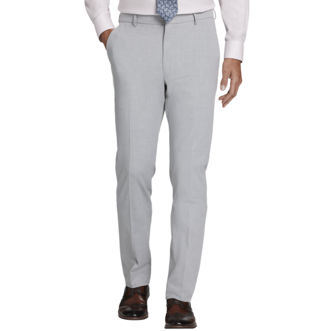 A man is wearing light gray dress pants paired with a white shirt, blue patterned tie, and brown dress shoes.