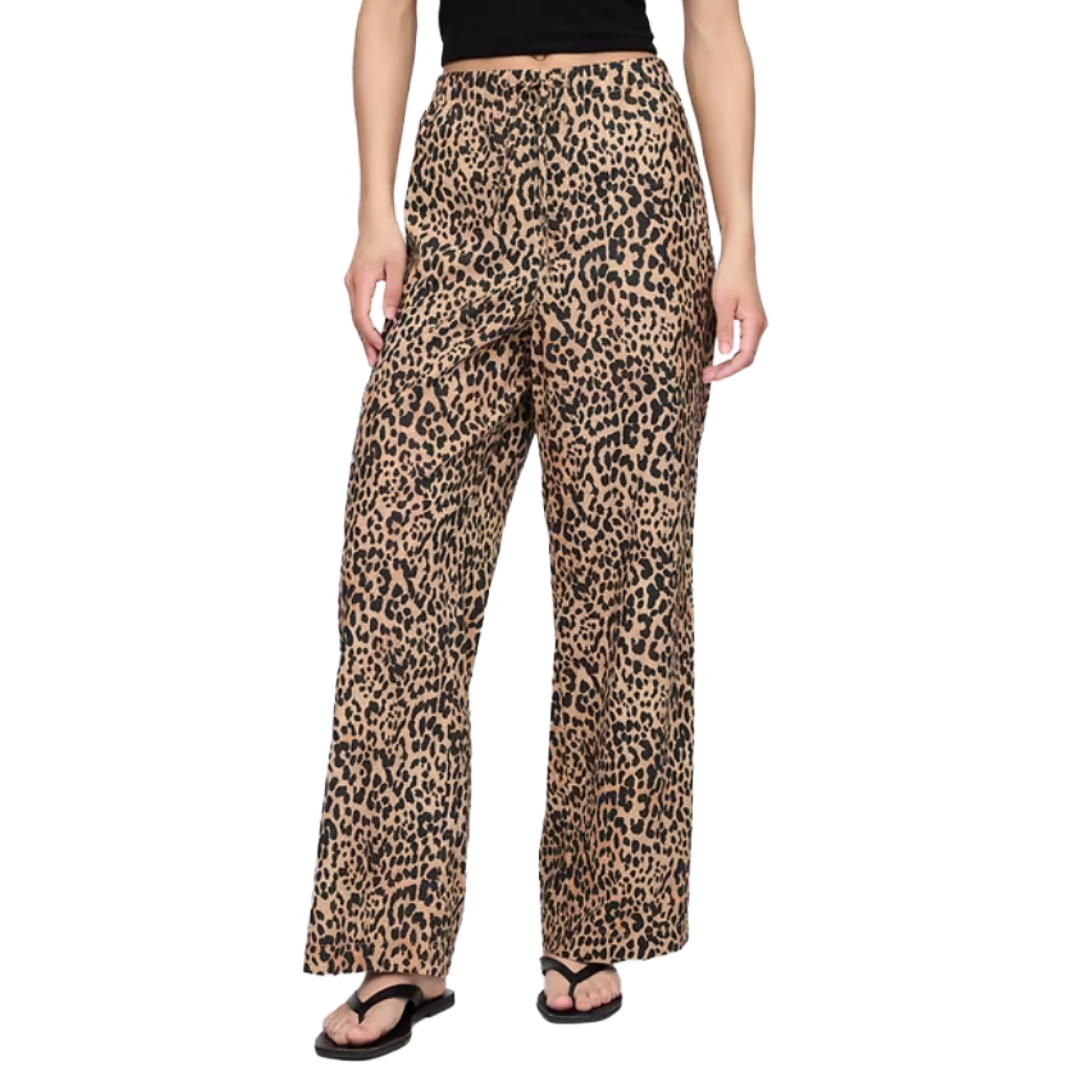 Wide-leg pants with a leopard print pattern paired with black flip-flops and a black top.