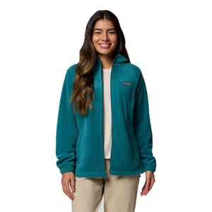 A woman is wearing a teal Columbia fleece jacket with a full zip and elastic cuffs, paired with beige pants.