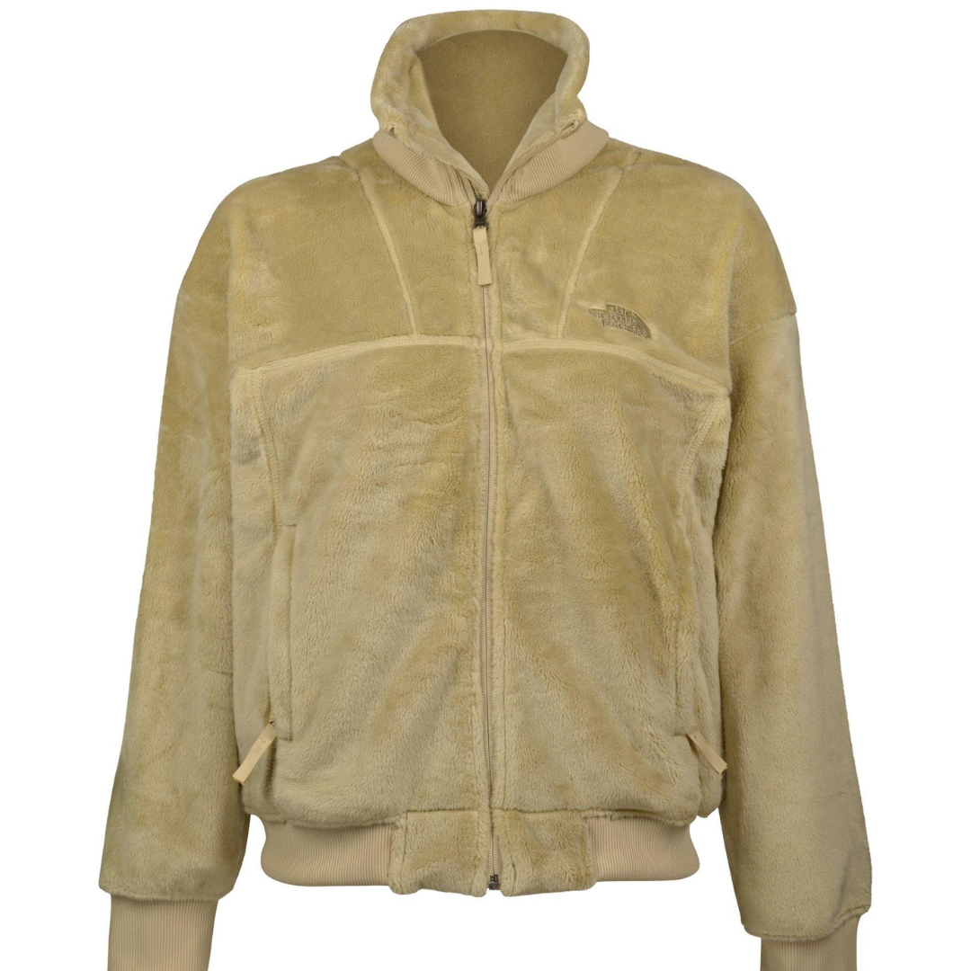 A beige fleece jacket from The North Face with a full zipper, high collar, and ribbed cuffs and hem.
