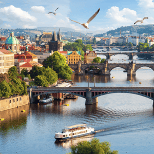 A scenic view of Prague with multiple historic bridges spanning the Vltava River, featuring boats on the water and seagulls flying above.