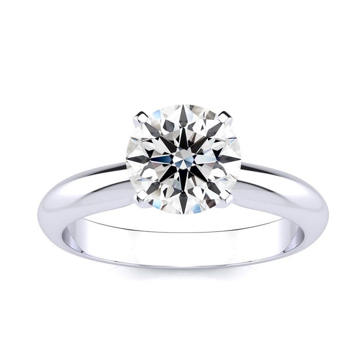 A polished white gold ring featuring a 1.5-carat round diamond in a classic four-prong setting, designed for a sleek and elegant look.