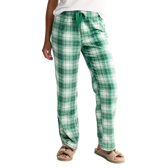 Green plaid pajama pants with a drawstring waist, paired with fuzzy beige slippers.