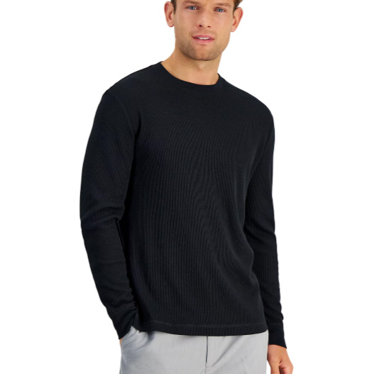 A man is wearing a long-sleeved, black ribbed thermal sweater with a crew neckline. The sweater has a textured pattern and a fitted design.