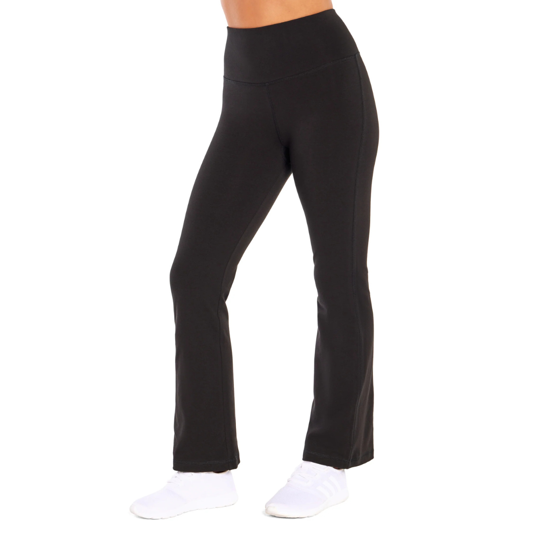 Black high-waisted, flared yoga pants with white athletic shoes.
