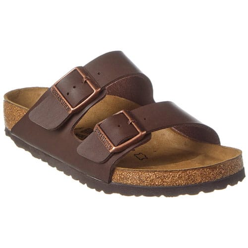 A brown sandal with two adjustable straps and a cork footbed, featuring a non-slip sole and metallic buckles.