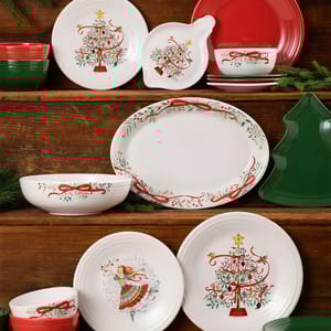 Festive dinnerware collection with Christmas tree and ribbon motifs, featuring plates, bowls, and an oval platter. Includes green and red solid color pieces, and a tree-shaped tray. Perfect for holiday settings.