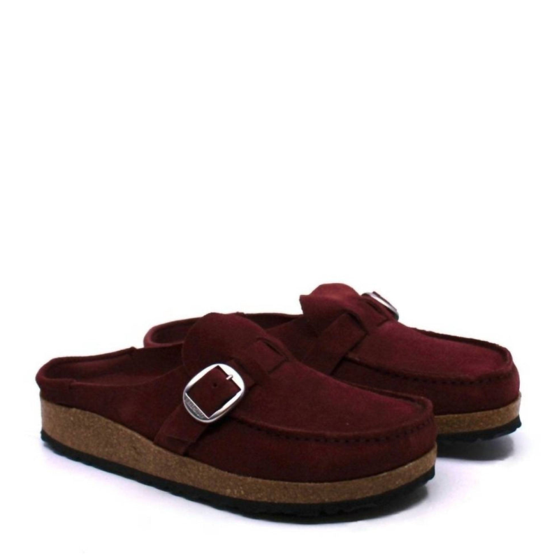 Maroon suede slip-on clogs with a cork sole, featuring a silver buckle detail.