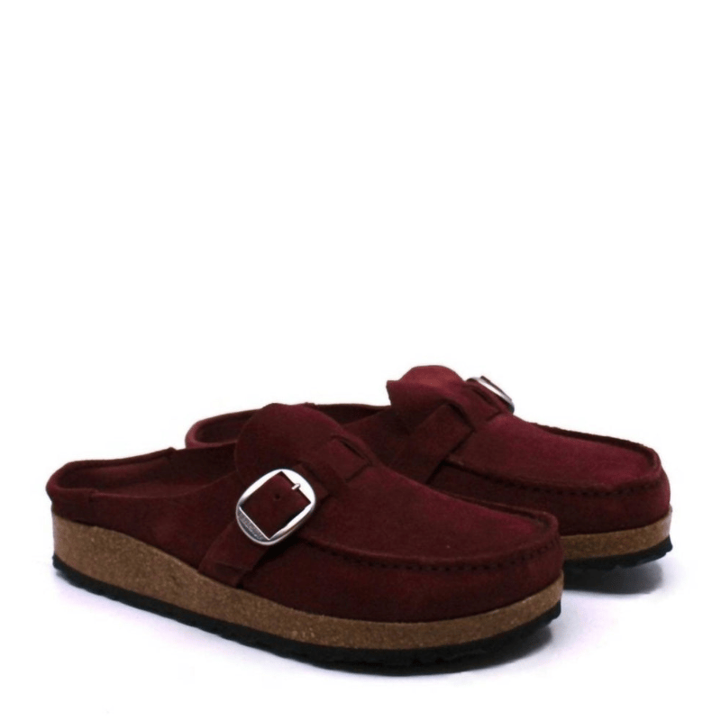 Maroon suede slip-on clogs with a cork sole, featuring a silver buckle detail.