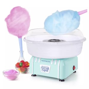 A Nostalgia Cotton Candy Maker is shown with a clear rimmed lid above a pastel blue base, accompanied by pink and blue cotton candy on sticks, and a bowl of flavored sugar.