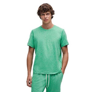 A person is wearing a green short-sleeve T-shirt paired with matching green drawstring shorts.