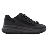 A black sneaker featuring a sleek, all-black design with a thick sole, mesh panels, and lacing for closure. The shoe includes branded elements and a \“Pro-Tech\“ insignia on the midsole.