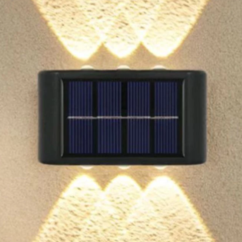 Wall-mounted solar-powered light with dual illumination to provide lighting above and below.