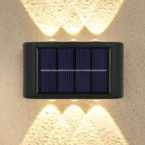 Wall-mounted solar-powered light with dual illumination to provide lighting above and below.