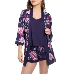 A woman wears a floral-patterned dark blue kimono-style robe with matching shorts and a tank top underneath.