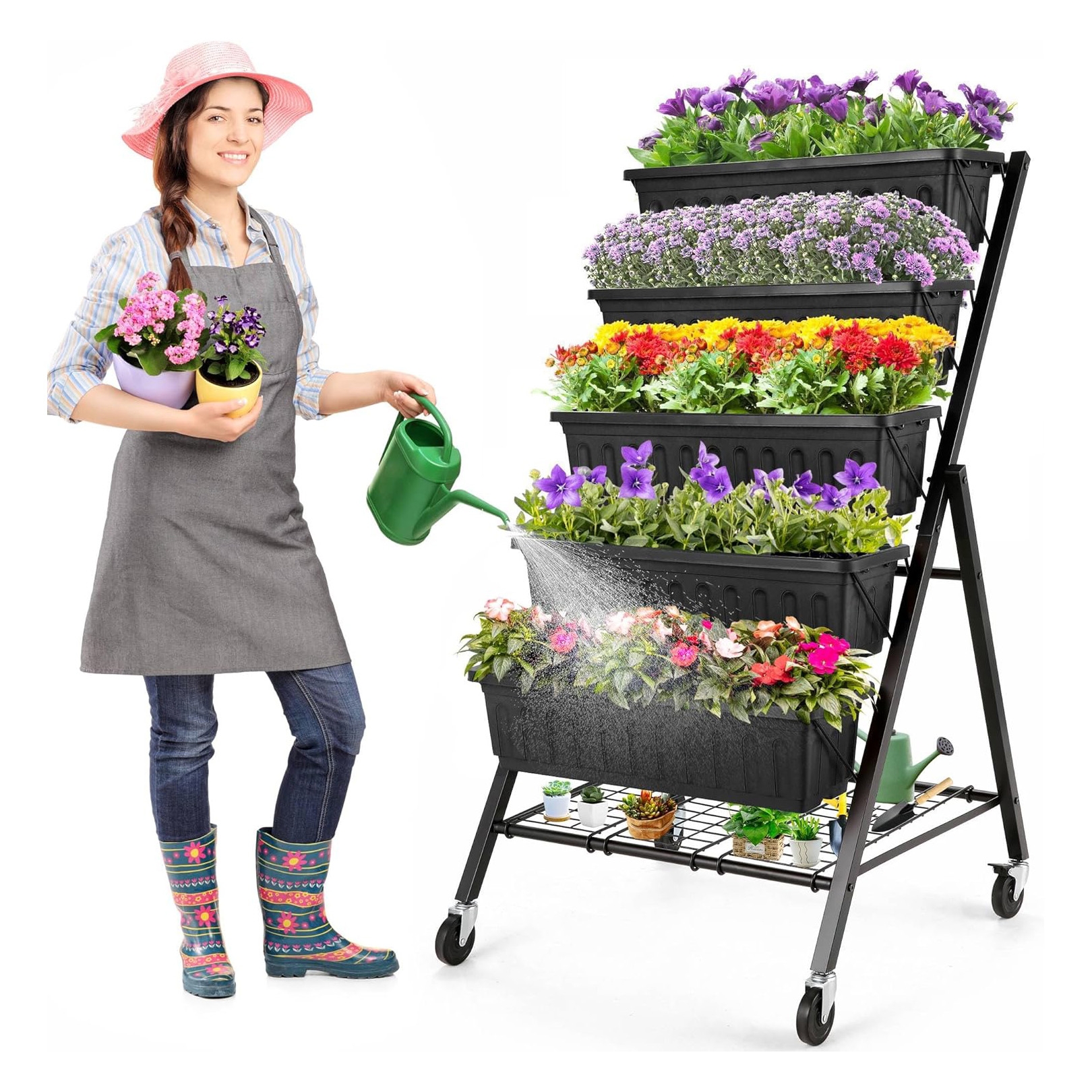 A woman in gardening attire is watering flowers on a multi-tiered plant stand.