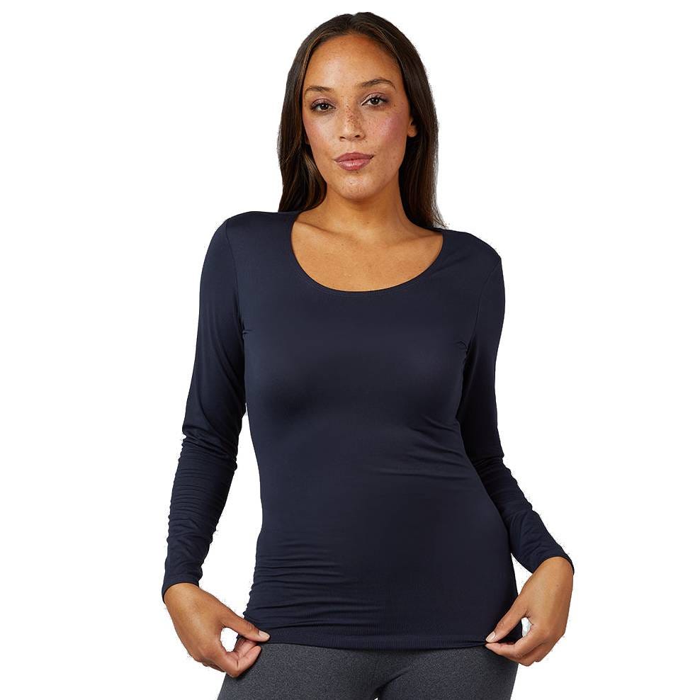 A woman is wearing a fitted, long-sleeve, scoop-neck navy top paired with dark leggings.