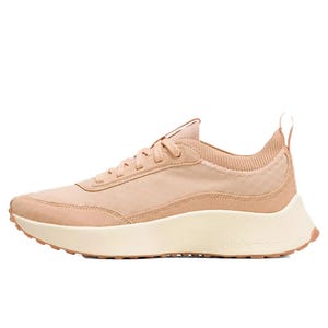 A beige athletic sneaker with a knit collar, lace-up design, and cushioned off-white sole, featuring the brand name \“lululemon\“ on the side.