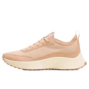 A beige athletic sneaker with a knit collar, lace-up design, and cushioned off-white sole, featuring the brand name \“lululemon\“ on the side.