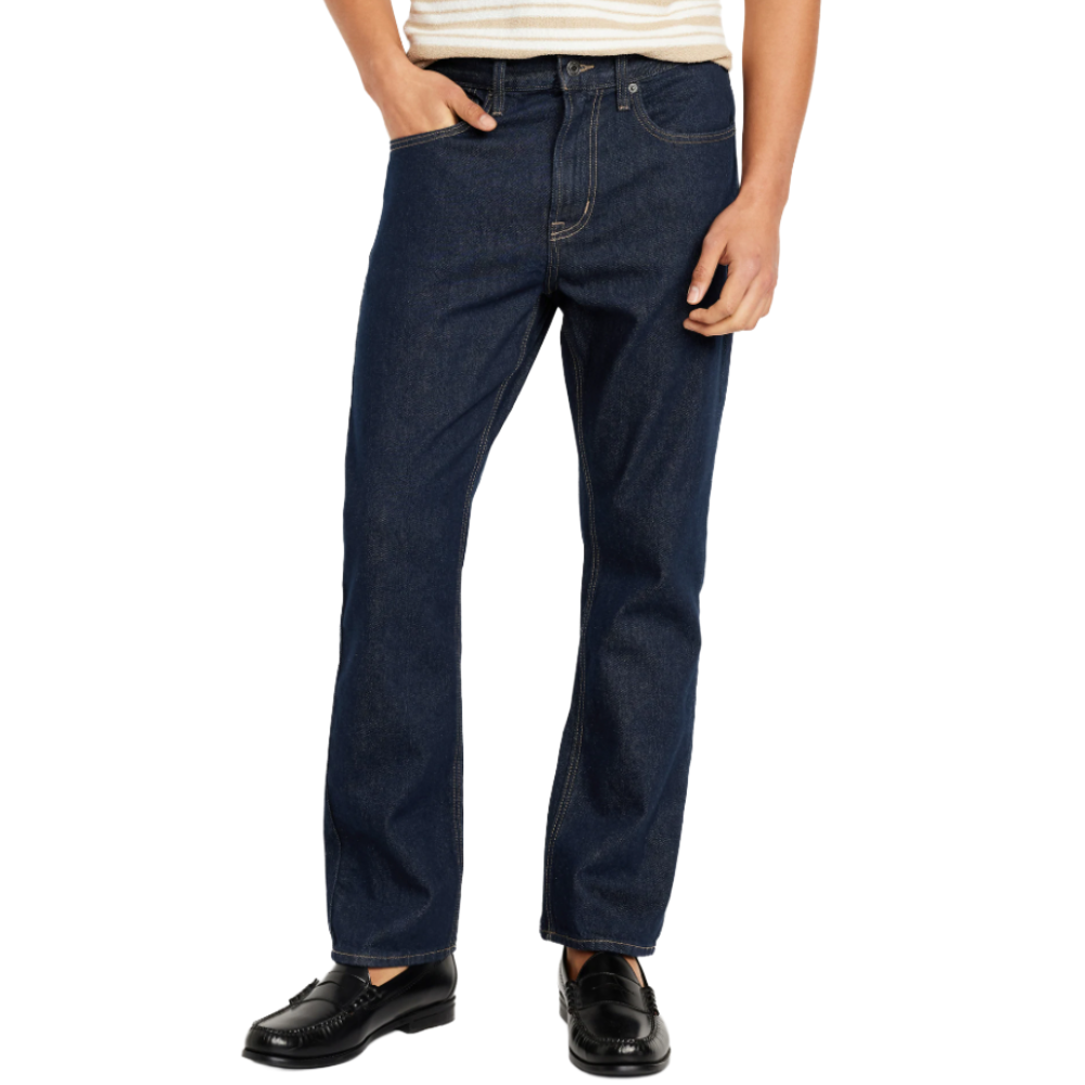 A person is wearing dark blue jeans paired with black loafers and a striped shirt.