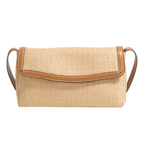 A woven straw clutch with brown leather trim and a shoulder strap.