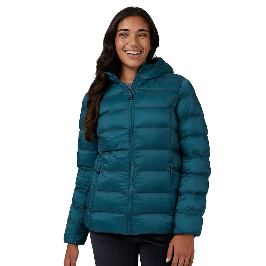 A woman is wearing a teal-colored hooded puffer jacket with horizontal quilting and side pockets.