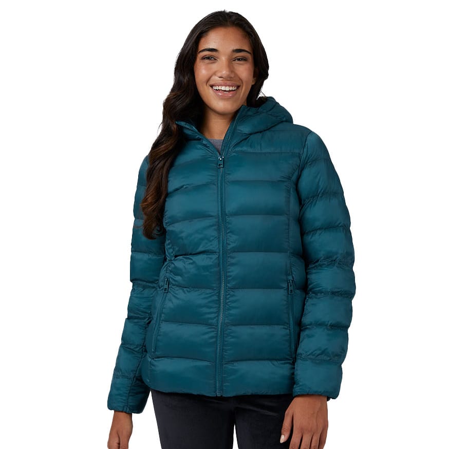 A woman is wearing a teal-colored hooded puffer jacket with horizontal quilting and side pockets.