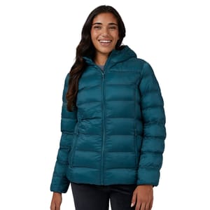 A woman is wearing a teal-colored hooded puffer jacket with horizontal quilting and side pockets.