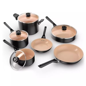 A set of black cookware with beige non-stick interiors, including pots, pans, and a skillet, some with glass lids.