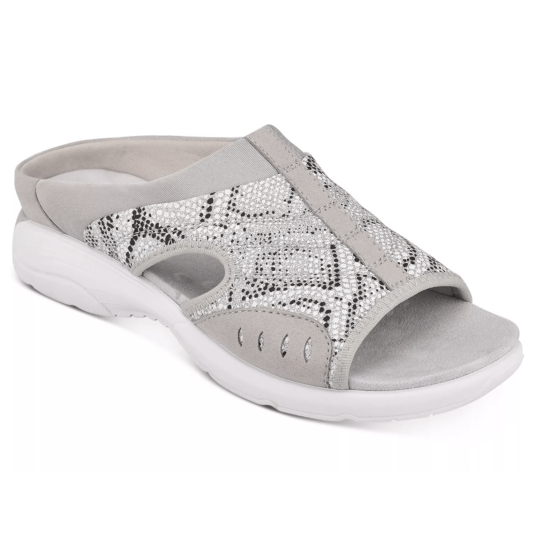 A light gray slip-on sandal with a white sole and open toe design, featuring a snakeskin pattern with metallic accents for casual wear.