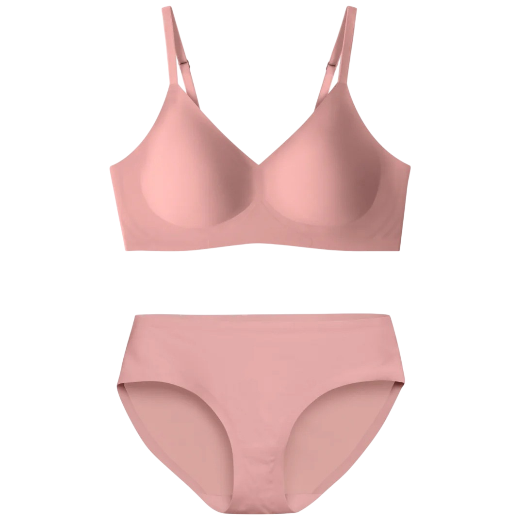 A light pink seamless bra and panty set with adjustable straps and smooth fabric for comfort and a minimalist appearance.