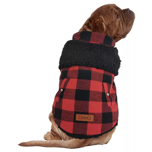 Dog wearing a red and black plaid coat with a black sherpa lining and two buttoned pockets, featuring a decorative patch.