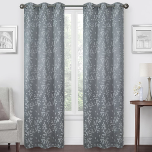 A pair of gray curtains with a leaf pattern hanging on a window.