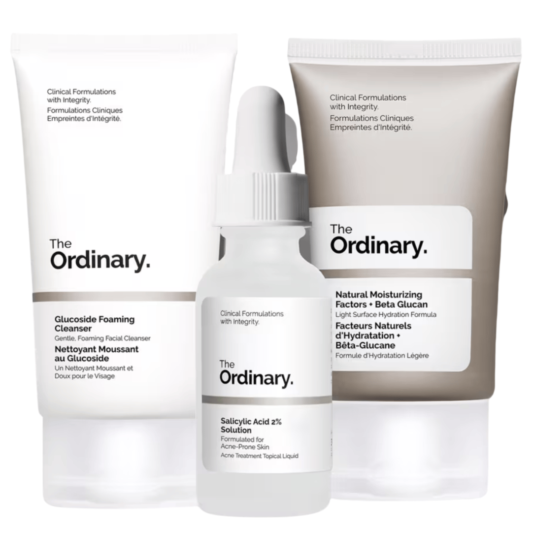 The photo shows three The Ordinary skincare items: a Glucoside Foaming Cleanser, a Salicylic Acid 2% Solution, and a Natural Moisturizing Factors + Beta Glucan.