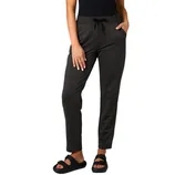 A person is wearing black drawstring pants paired with black sandals featuring buckles, posed against a neutral gray background.