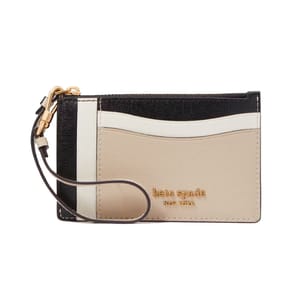 A rectangular wristlet with black, white, and beige color blocks, gold-tone hardware, and the \“kate spade new york\“ logo. It includes a wrist strap for easy carrying.