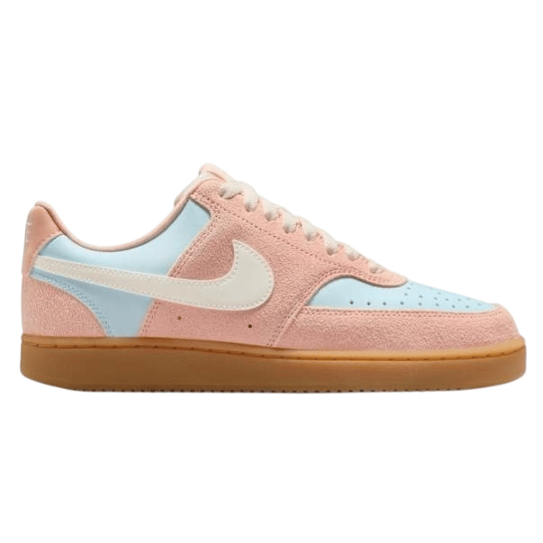 Low-cut sneaker in pink and light blue with a suede texture, featuring a white swoosh logo and a gum sole.