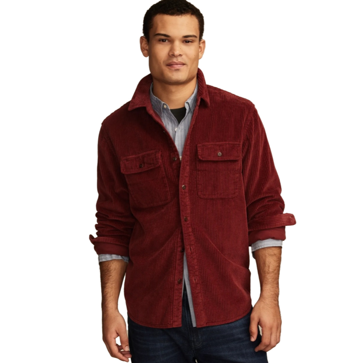 A man wears a burgundy corduroy shirt jacket with two chest pockets, paired with a blue button-up shirt underneath.