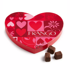 Heart-shaped box of Frango Mint Chocolates with a red and pink design featuring hearts and flowers, accompanied by three chocolate pieces.
