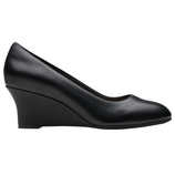 A black wedge pump featuring a closed toe and a medium-height wedge heel, designed with a smooth, matte finish.