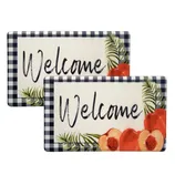 Two rectangular mats with a \“Welcome\“ message, featuring a checkered border and floral designs with peaches and leaves.
