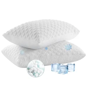 Two textured white pillows are depicted with snowflakes, suggesting cooling properties. Ice cubes and a close-up of filling material are shown, emphasizing cooling technology.