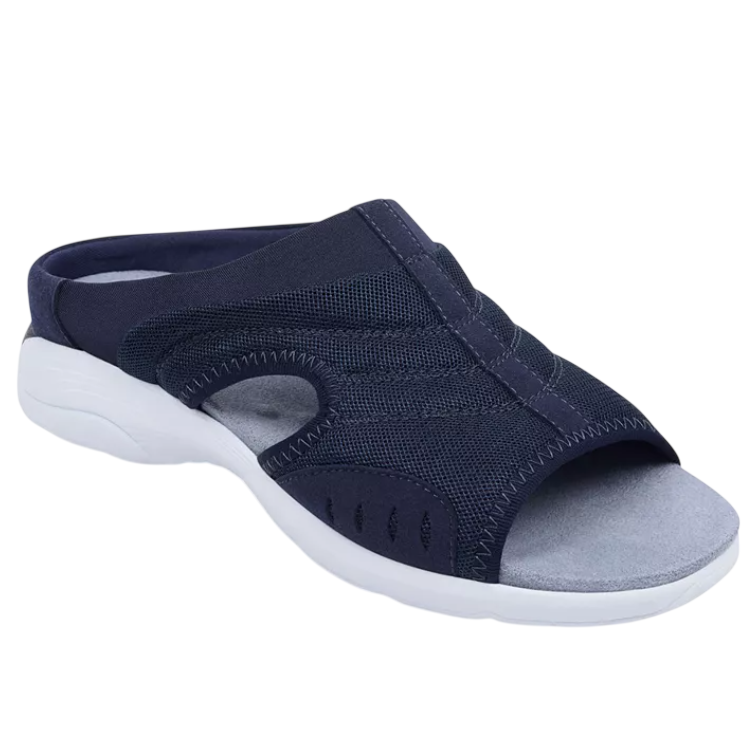 A navy blue slip-on sandal with a white sole, featuring a mesh design and open-toe style.