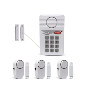 A home security system with a keypad, door sensors, and alarm units. The components include a keypad with a panic button and switch settings, and several wireless magnetic door/window alarm sensors.