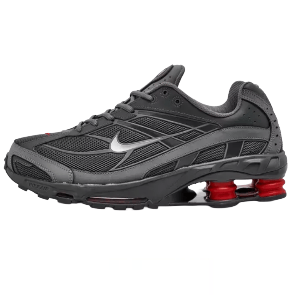 Gray Nike running shoe with a silver swoosh and distinctive red cushioning springs in the heel.