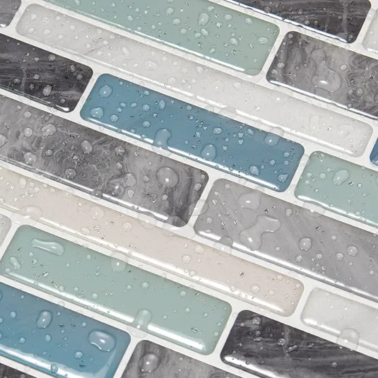 A set of rectangular adhesive mosaic tiles with a glossy finish, featuring a mix of blue, gray, and white colors, and covered with water droplets.