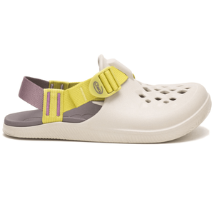 A beige clog-style shoe with a perforated upper, featuring a yellow adjustable strap and a purple heel strap.
